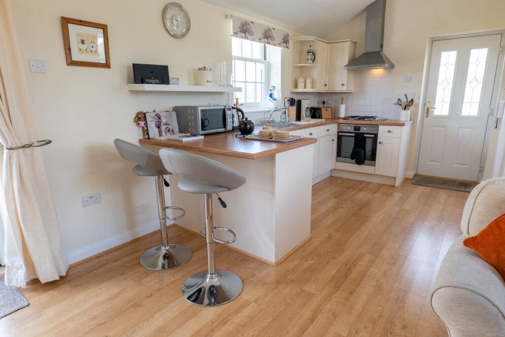 Open-plan kitchen and breakfast bar at Derwent View Cottage